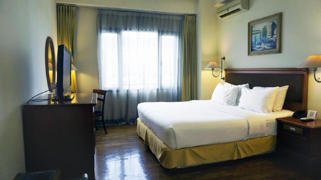Postel nebo postele na pokoji v ubytování Mega Anggrek Hotel Jakarta Slipi