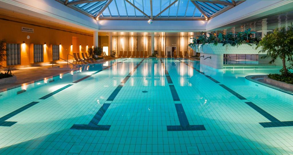 a large swimming pool in a building at Heide Spa Hotel &amp; Resort in Bad Düben