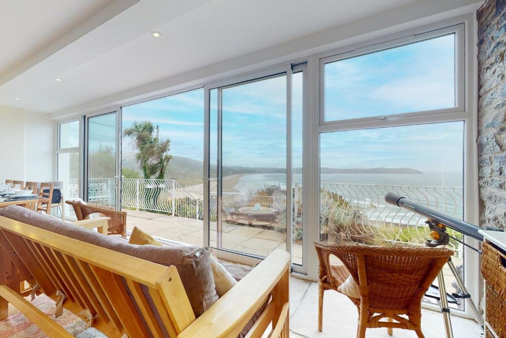 a living room with a view of the ocean at Superb Panoramic Sea Views Sleeps 10 Pet Friendly in Woolacombe