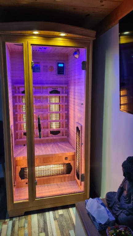 a room with a shower with purple lights at Hookah Apartment 13 in Budapest