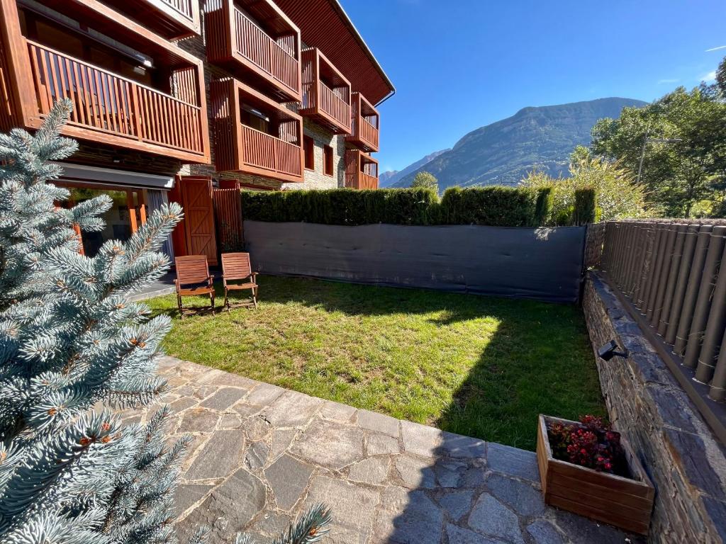 a house with a christmas tree in the yard at B49 - Bajo con Jardín Peguera - Villmor in Benasque
