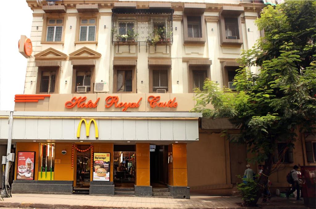 a mcdonalds restaurant in front of a building at Hotel Royal Castle in Mumbai