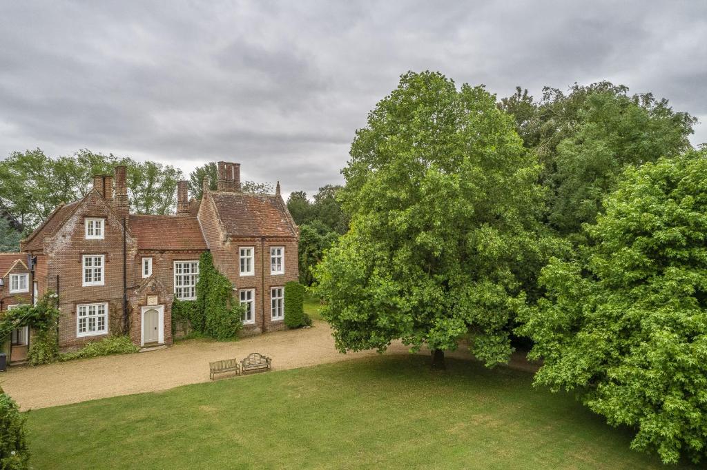 an old house with a tree in front of it at The Old Rectory - Norfolk in North Tuddenham