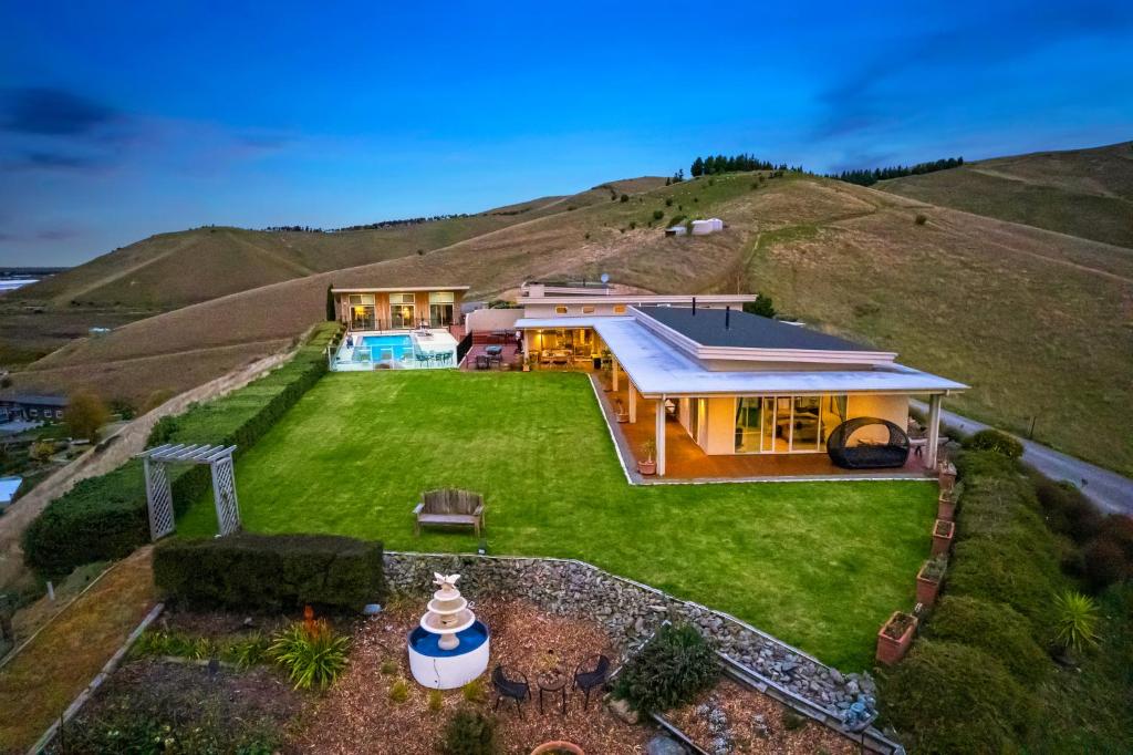 an aerial view of a house on a hill at Mountainview Villa Luxury Lodge & Glamping in Blenheim