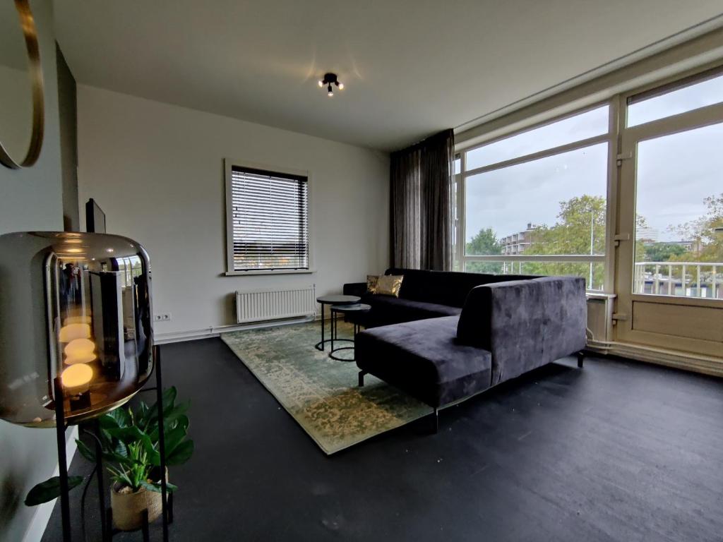 a living room with a couch and a large window at K50167Spacious and modern apartment near the city center, free parking in Eindhoven