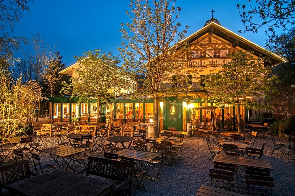 a group of tables and chairs in front of a building at Landhaus Hotel Wolfratshausen in Wolfratshausen