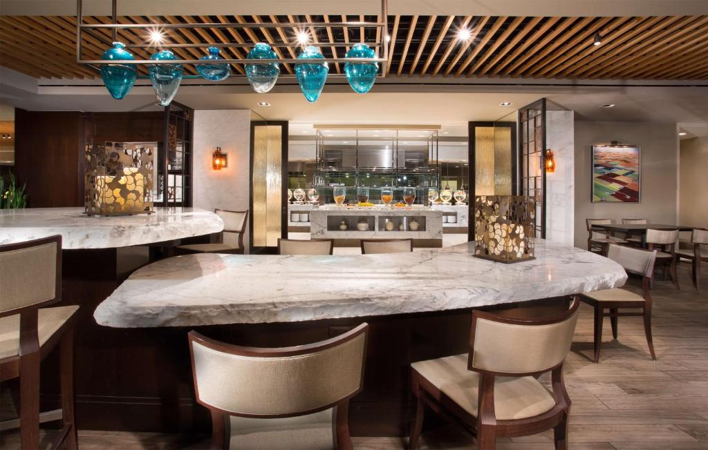 a bar with a large marble counter in a restaurant at New York Hilton Midtown in New York