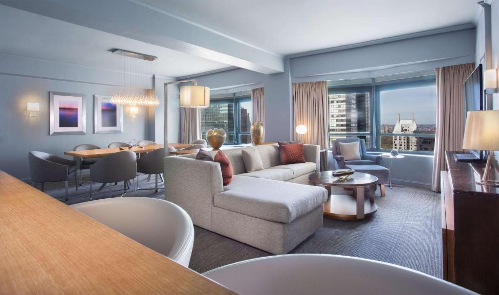 a living room with a couch and a table at New York Hilton Midtown in New York