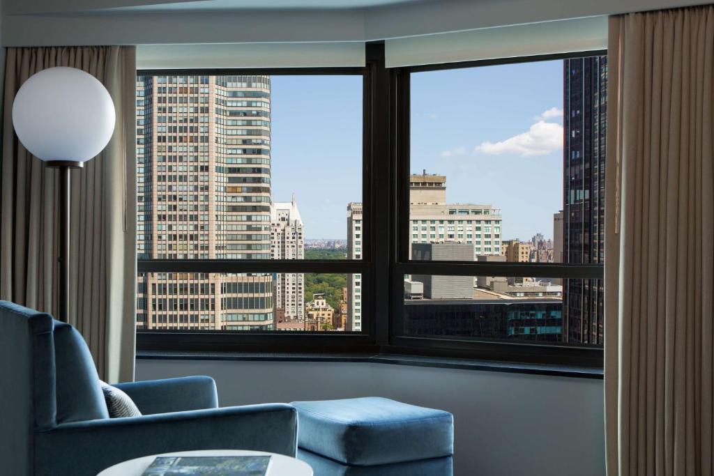 a living room with a view of a city at New York Hilton Midtown in New York