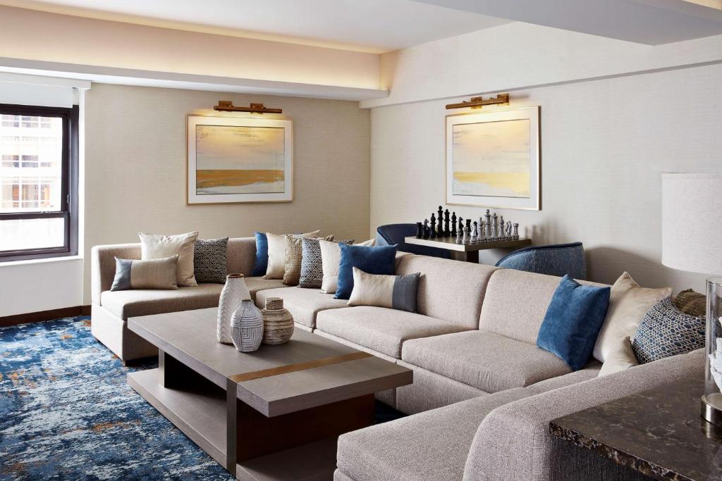 a living room with a couch and a table at New York Hilton Midtown in New York
