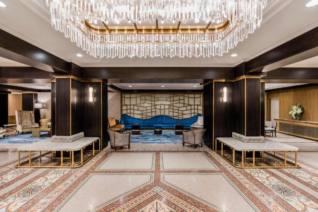 a large lobby with a large chandelier at Martinique New York on Broadway, Curio Collection by Hilton in New York