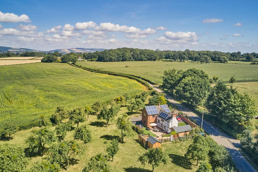 an aerial view of a house in the middle of a field at Powk Meadow Farmhouse in Leominster