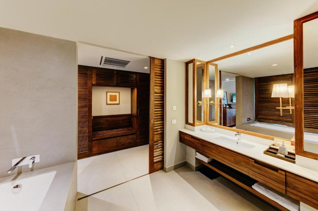 a bathroom with a sink and a mirror at Cinnamon Bentota Beach - Signature Selection in Bentota