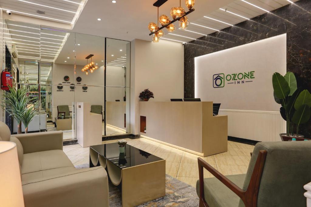 a lobby of a store with a couch and a table at Hotel Ozone Inn Colaba in Mumbai