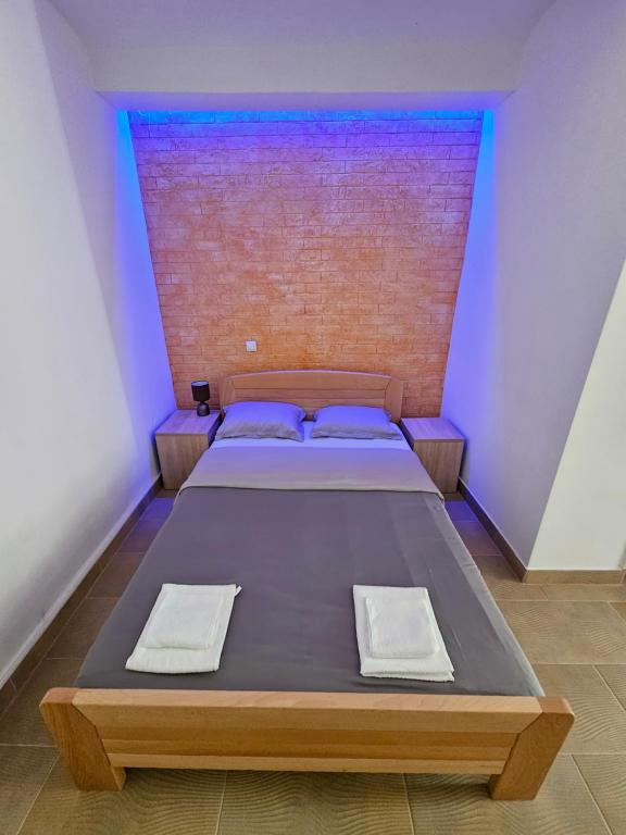 a bedroom with a bed with two pillows on it at Booking Apartments Alone 2 in Zemun