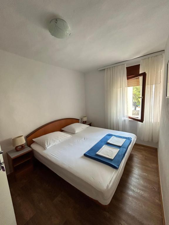 una camera da letto con un letto e un asciugamano blu di Sobe Gorana a Živogošće (Svogoschia)