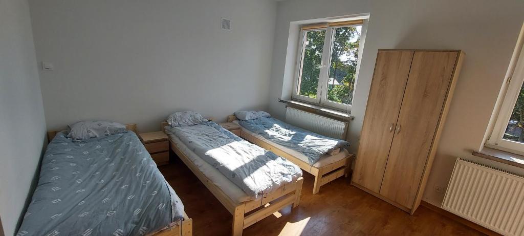 Habitación con 2 camas y ventana en U Witka, Tanie noclegi, Kwatery pracownicze, en Jaktorów