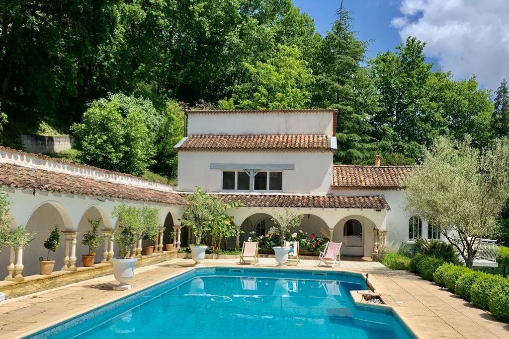 a villa with a swimming pool in front of a house at 1986MALAGAR in Baurech