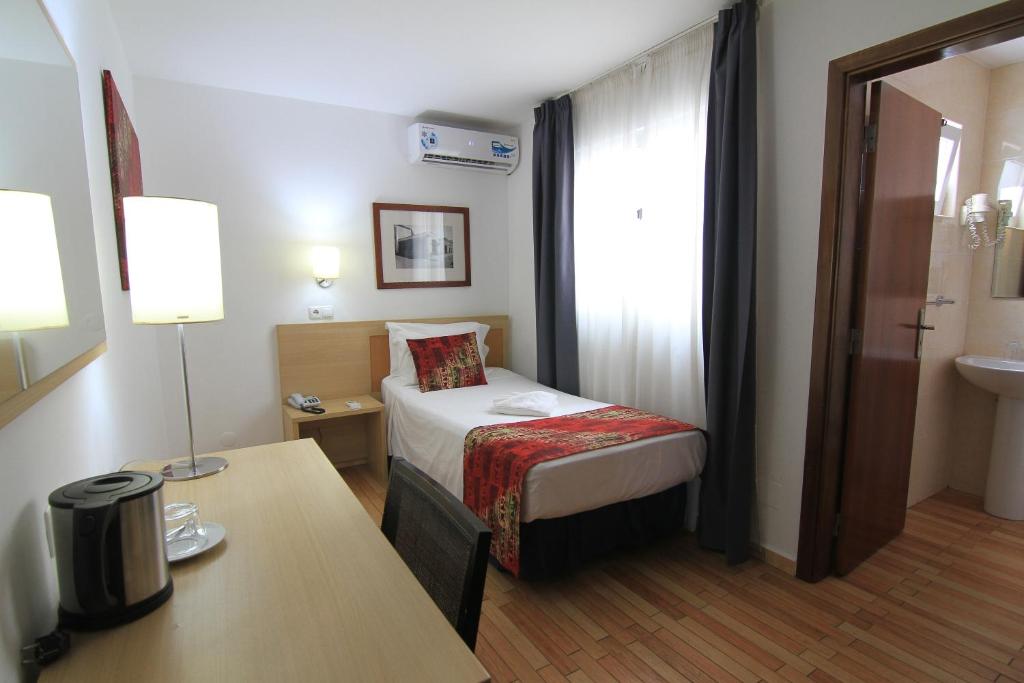 Postel nebo postele na pokoji v ubytování Hotel Santa Maria