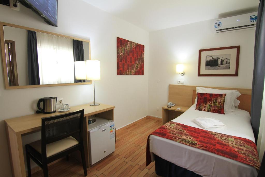 Postel nebo postele na pokoji v ubytování Hotel Santa Maria