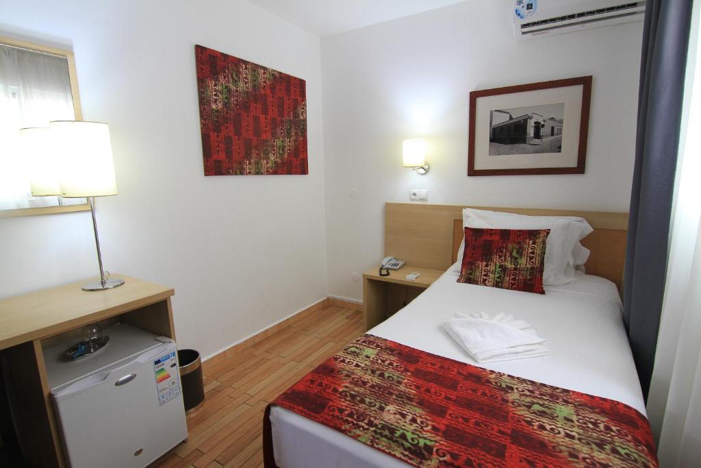 Postel nebo postele na pokoji v ubytování Hotel Santa Maria