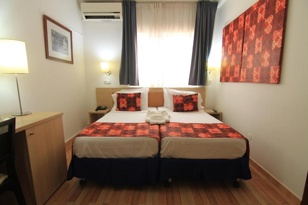 Postel nebo postele na pokoji v ubytování Hotel Santa Maria
