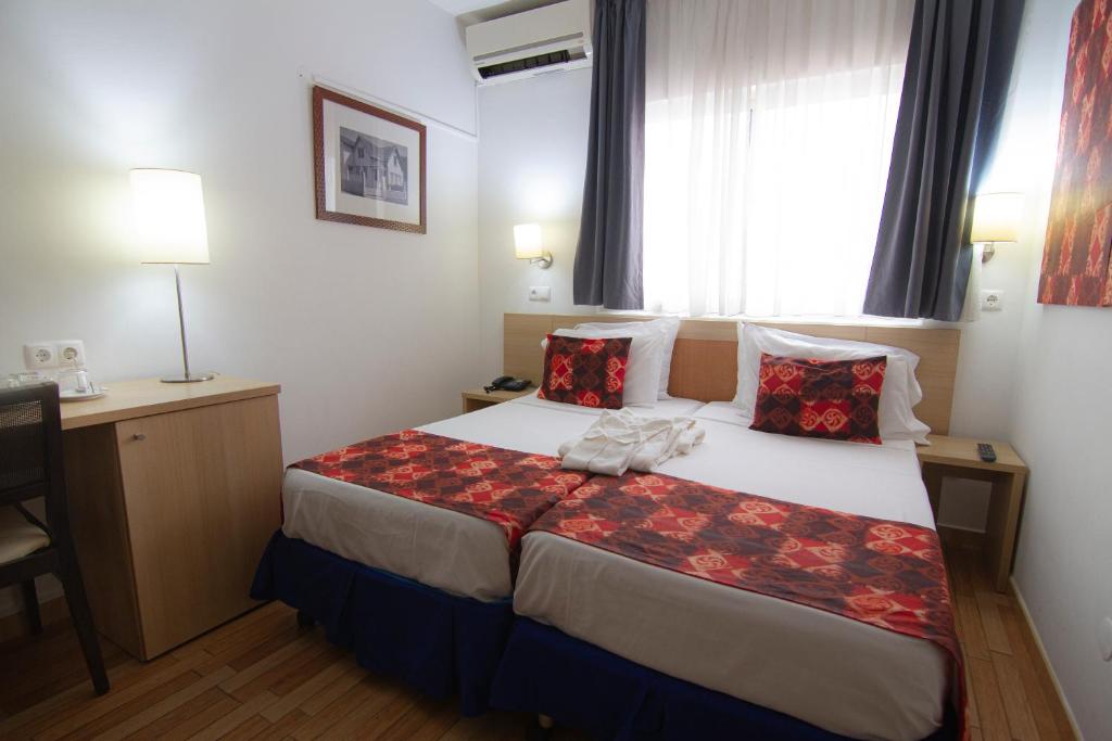 Postel nebo postele na pokoji v ubytování Hotel Santa Maria