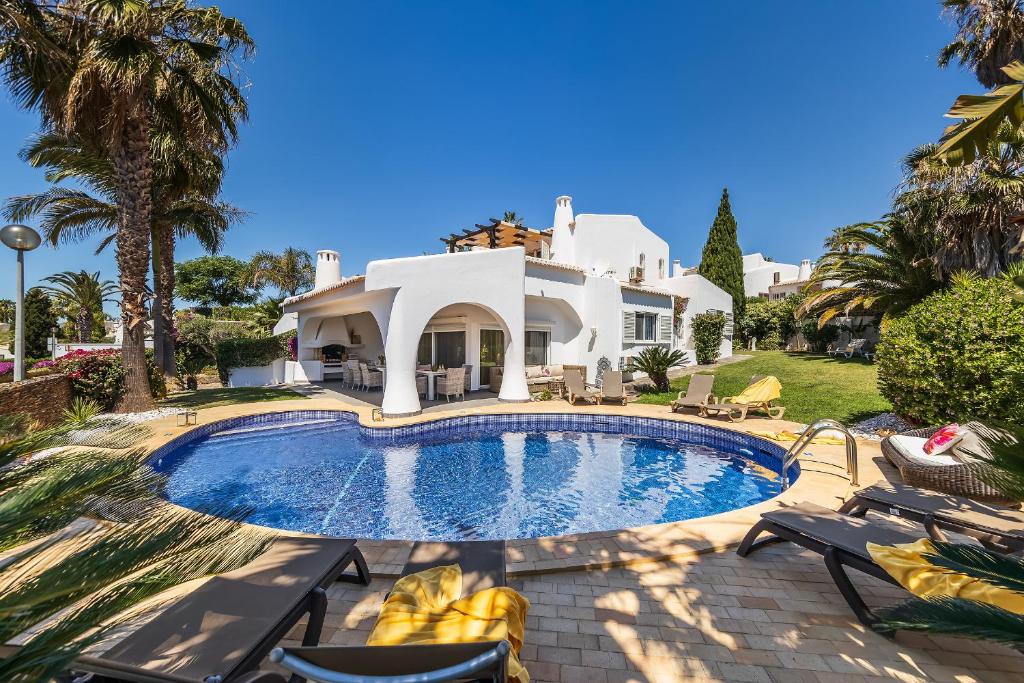 a large house with a swimming pool in front of it at Villa Eva by OCvillas in Albufeira