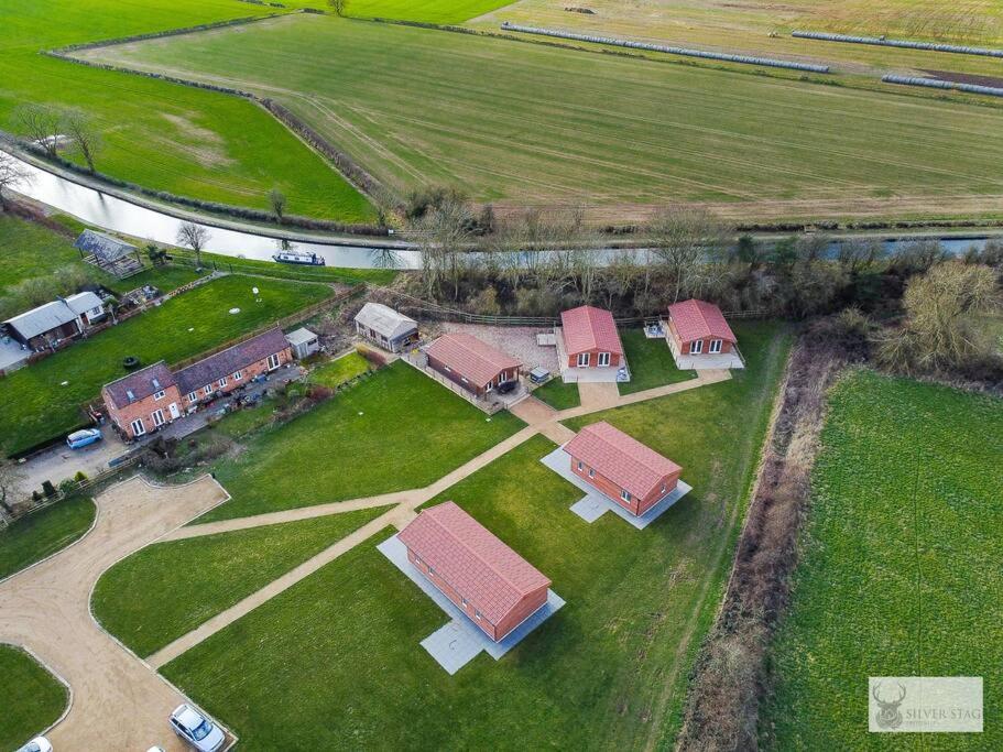an aerial view of a house in a field at Silver Stag Properties, 3 BR Sandstone Lodge 