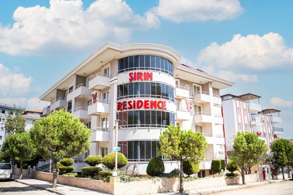 a white building with a sign that reads star residence at Sirin Residence in Denizli