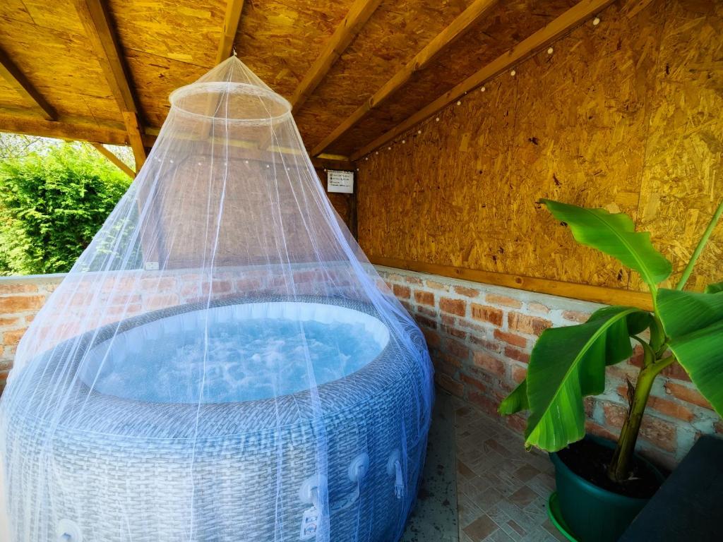 a hot tub with a net in a backyard at Charming Cottage Novo Čiče in Novo Čiče