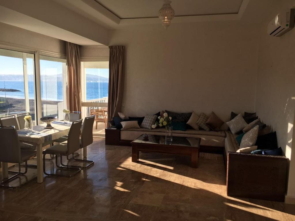 a living room with a couch and a table at Beautiful apartment with SEAVIEW Malabata in Tangier