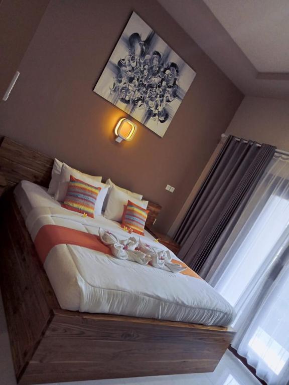 Postel nebo postele na pokoji v ubytování Semilir Inn Senggigi