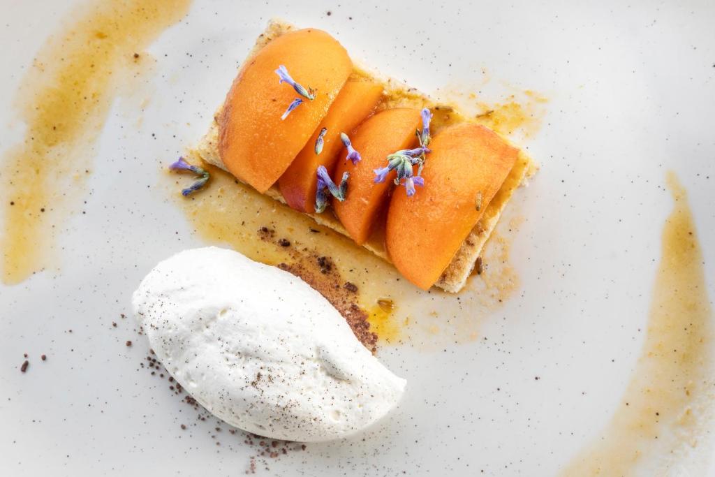 a piece of cake with fruit and a spoon at Melia Vienna in Vienna