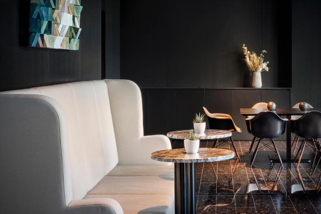a room with two tables and chairs and a couch at Melia Vienna in Vienna