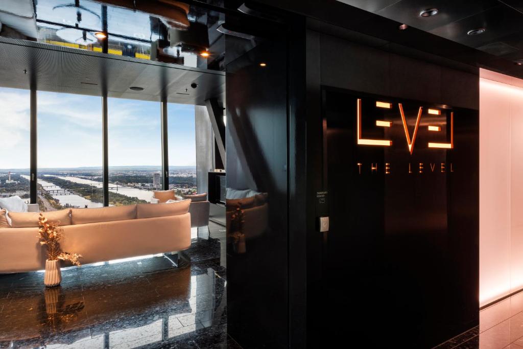 a room with couches and a sign on the wall at Melia Vienna in Vienna