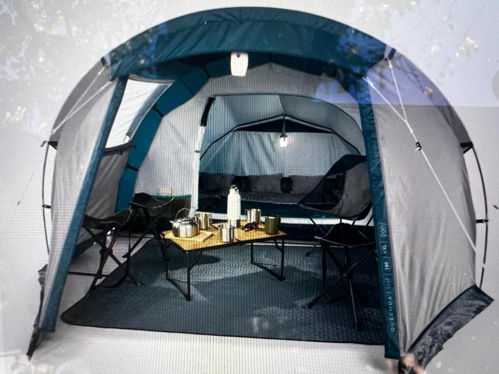 a tent with a table inside of it at Îlot Camping 