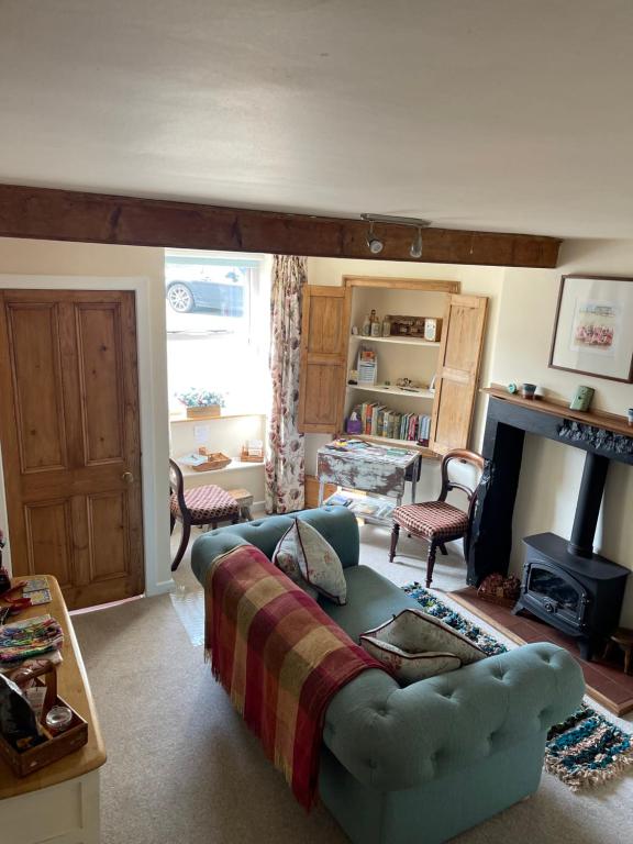 a living room with a couch and a fireplace at No.18 Holmfirth in Holmfirth