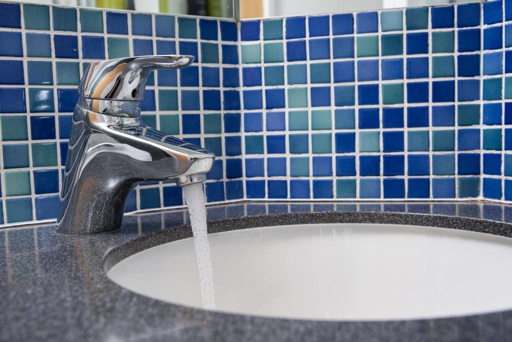 a sink with a water faucet in a bathroom at Holiday Inn Express Ramsgate – Minster by IHG in Minster