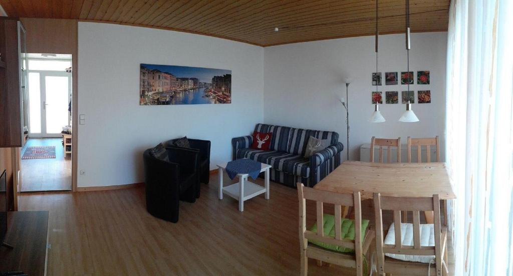 a living room with a couch and a table at Feriendorf Reichenbach - Wieselweg 3 in Nesselwang