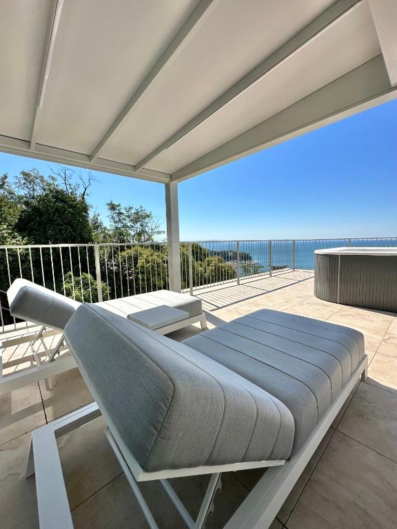 a bed on a patio with a view of the ocean at Maximilian Suites in Trieste