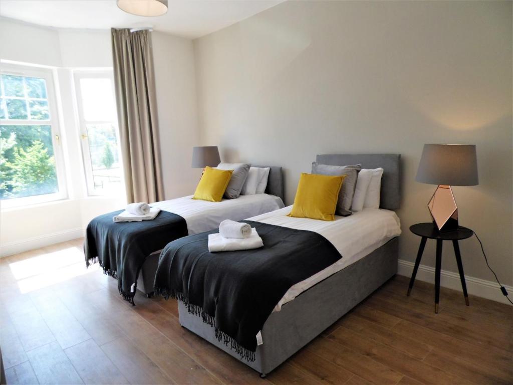 A bed or beds in a room at Signature - Langlands House