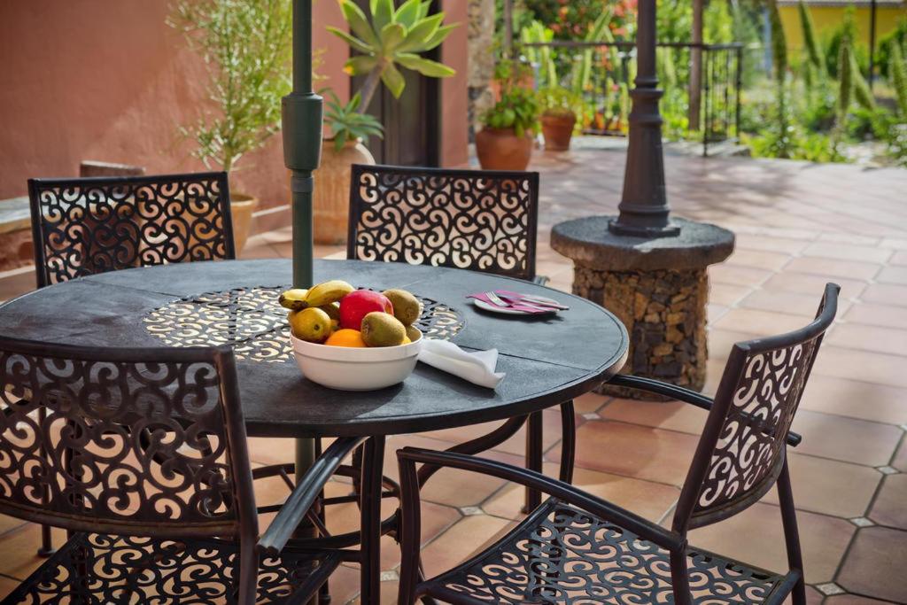 a table with a bowl of fruit on a patio at Tamahuche Hotel Rural in Vallehermoso