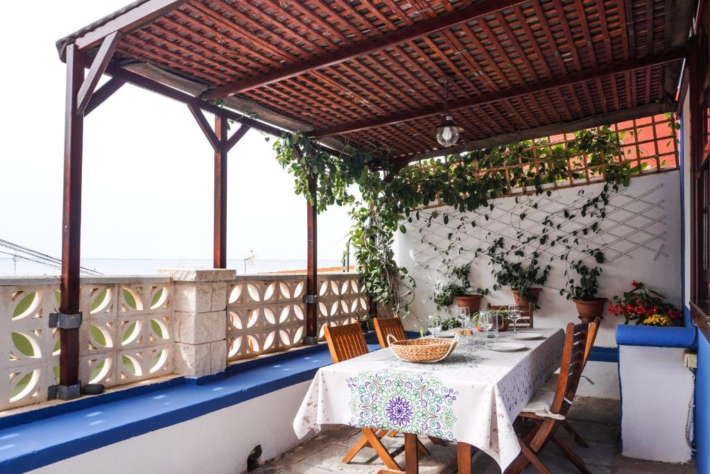 una mesa y sillas en un balcón con pérgola en Casa Yeyo, Lomo Bermejo, en Santa Cruz de Tenerife