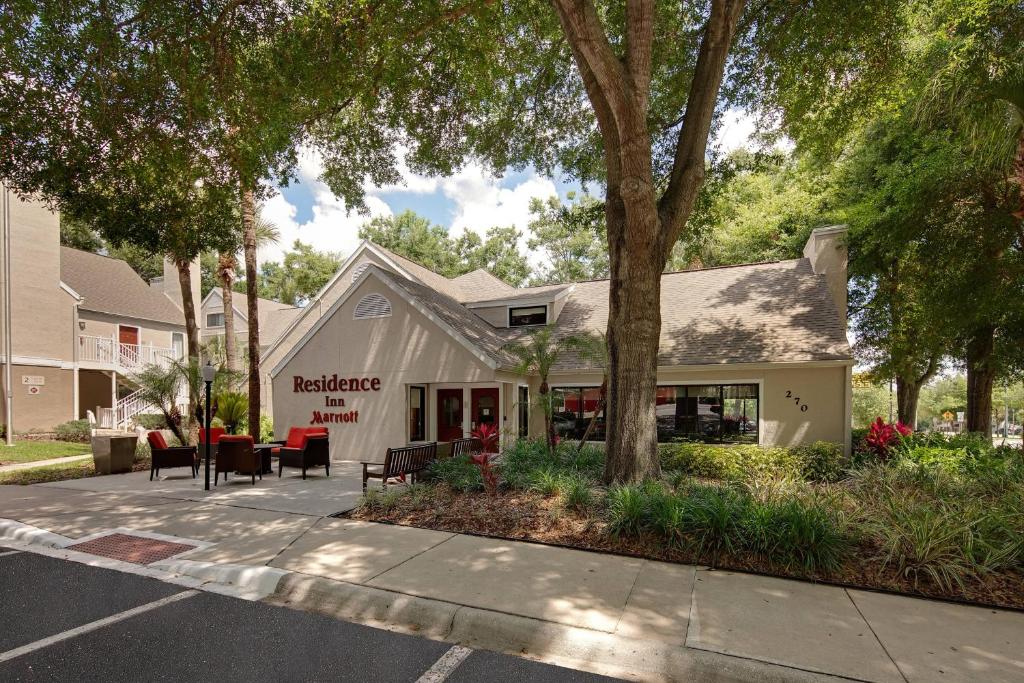 a building with tables and chairs outside of it at Residence Inn Orlando Altamonte Springs / Maitland in Orlando