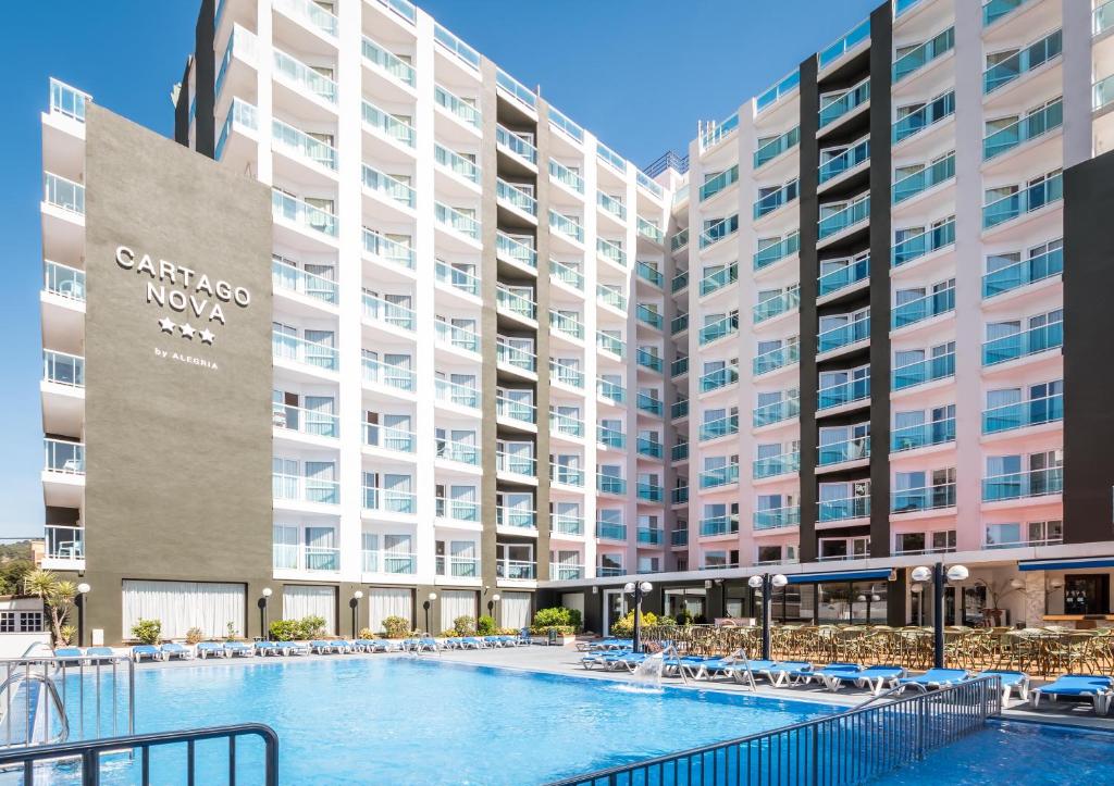 a large apartment building with a large swimming pool at Hotel Cartago Nova by ALEGRIA in Malgrat de Mar