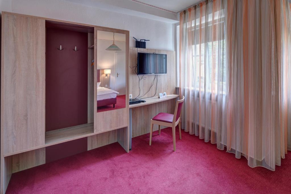 TV a/nebo společenská místnost v ubytování Hotel Leander