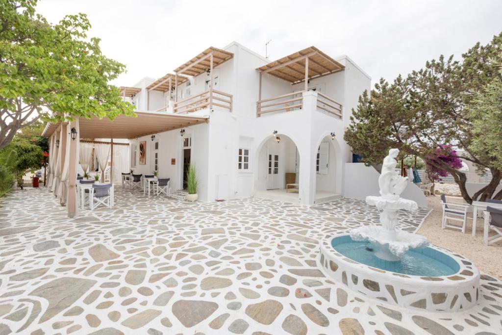 a house with a fountain in the middle of a courtyard at Acoya Residences in Aliki