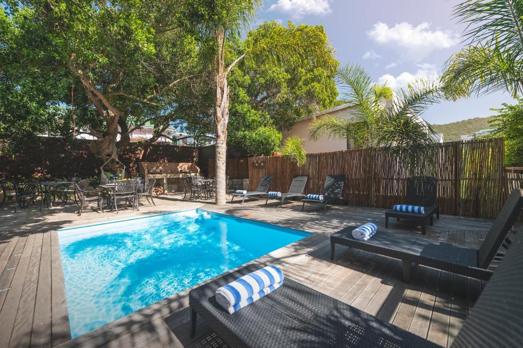 a swimming pool in a yard with chairs and a table at Thomasville in Wilderness