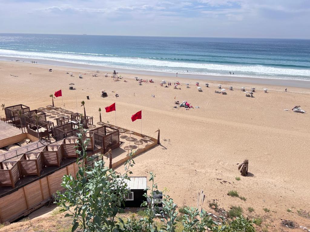 a beach with a lot of people and the ocean at The Paradise of ACHAKAR in Tangier